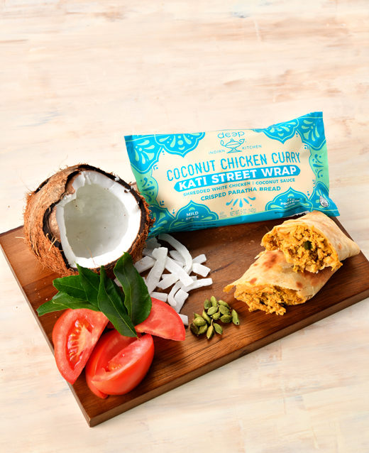 Coconut Chicken Curry Kati Street Wrap with ingredients surrounding