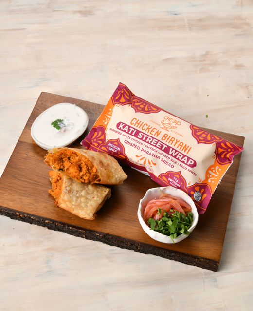 Chicken Biryani Kati Street Wrap with ingredients surrounding